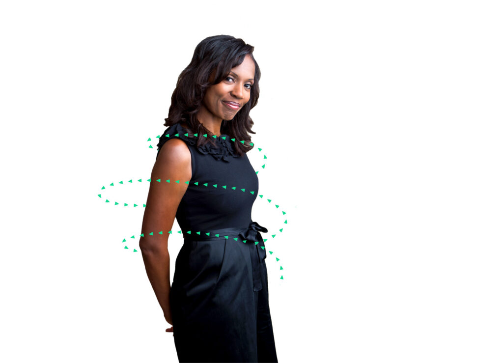 black woman in dress suit smiling with Kuvare logo arrows circling her body