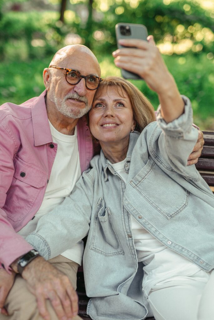 Woman in her 60s taking a selfie with her significant other