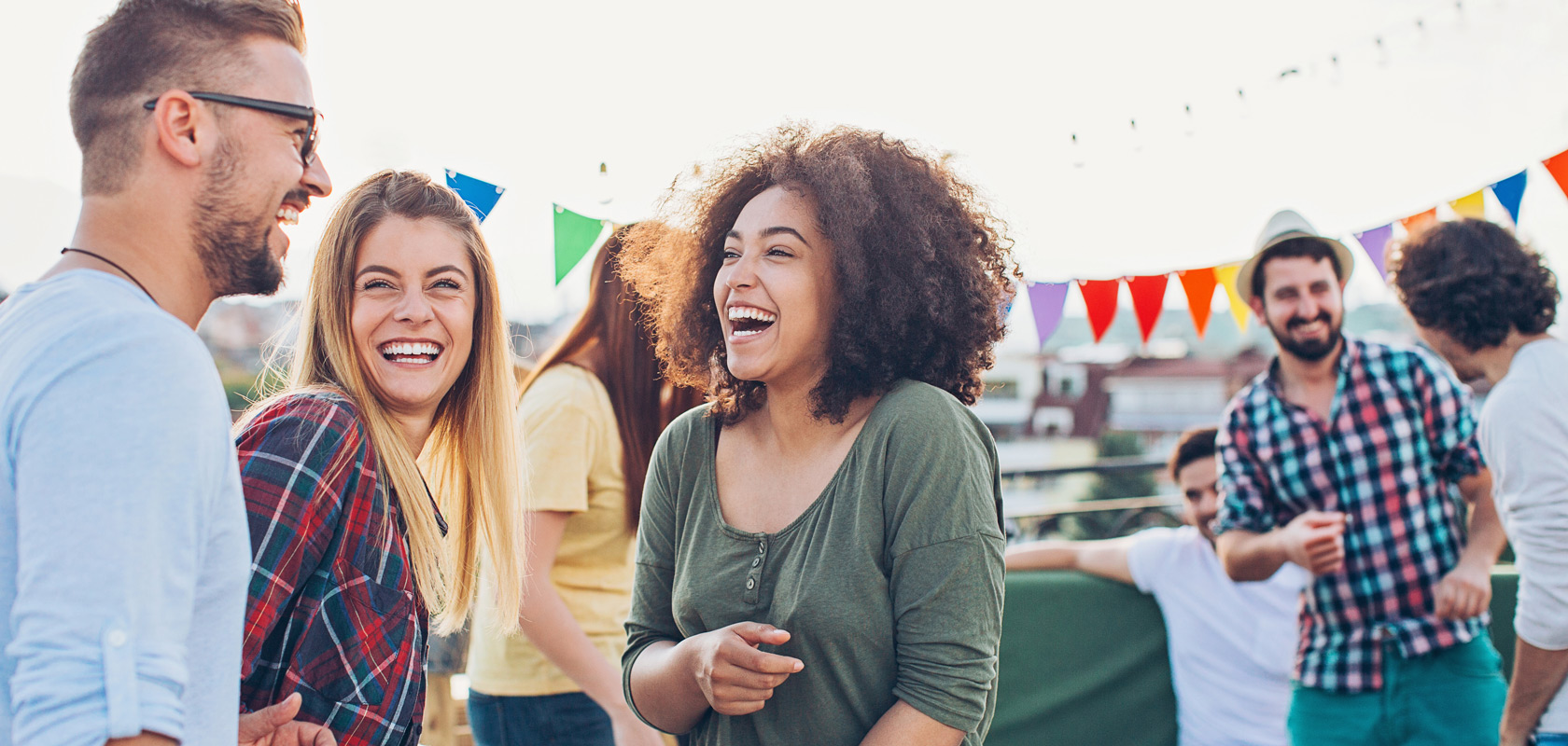 Happy people having a gathering on a rooftop.