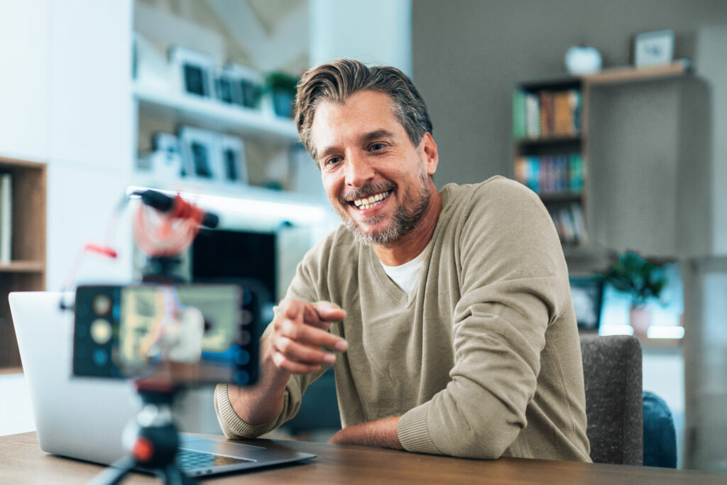 Male content creator happily recording content.