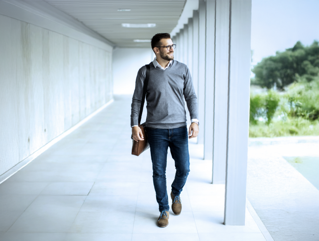 Young professional male walking in outdoor corridor