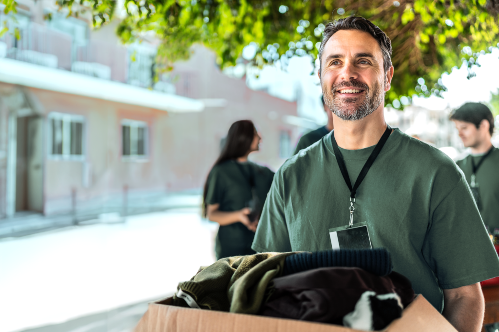 Man carrying box of donations to give to charity